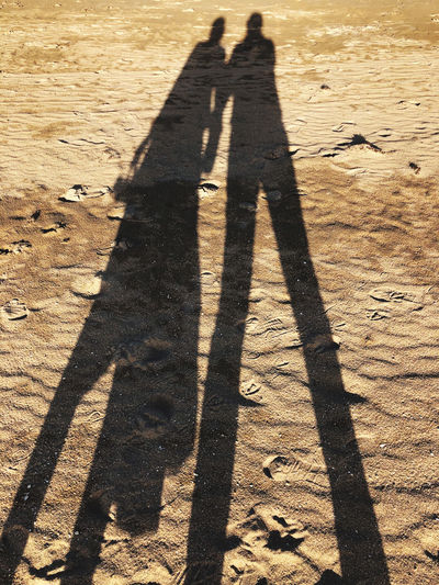 Shadow of people on sand