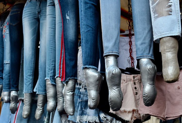 Jeans hanging at market stall for sale