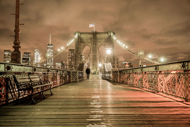 View of footbridge in city at night