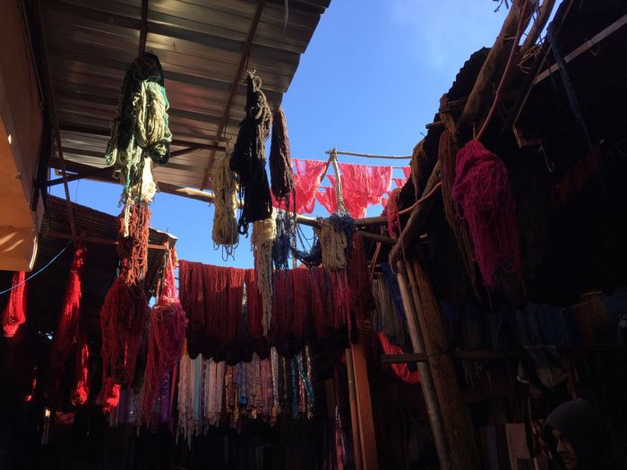 Low angle view of clothes drying against sky