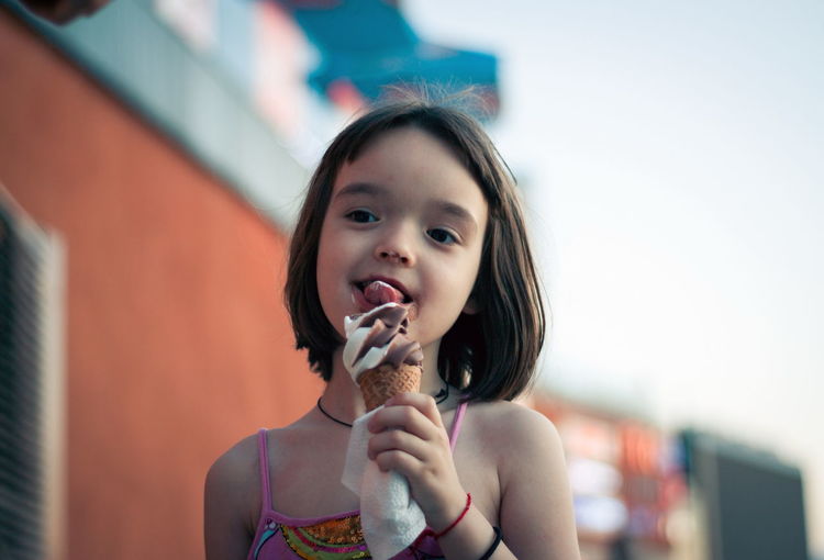 Little girl eating ice cream outdoors