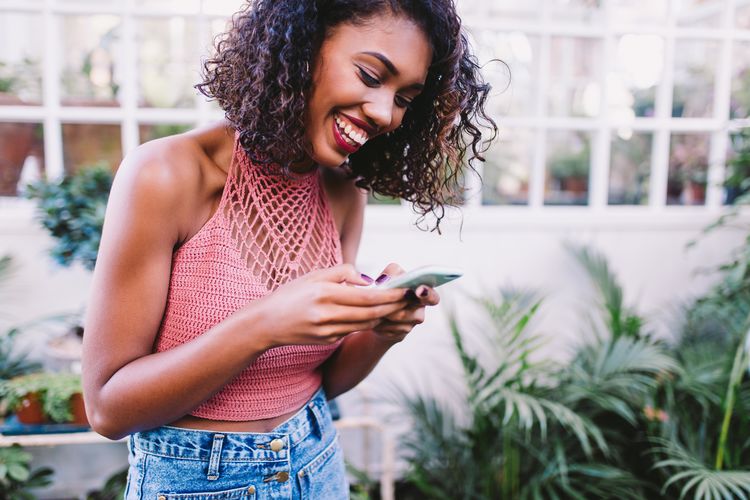 Close-up of young woman using mobile phone