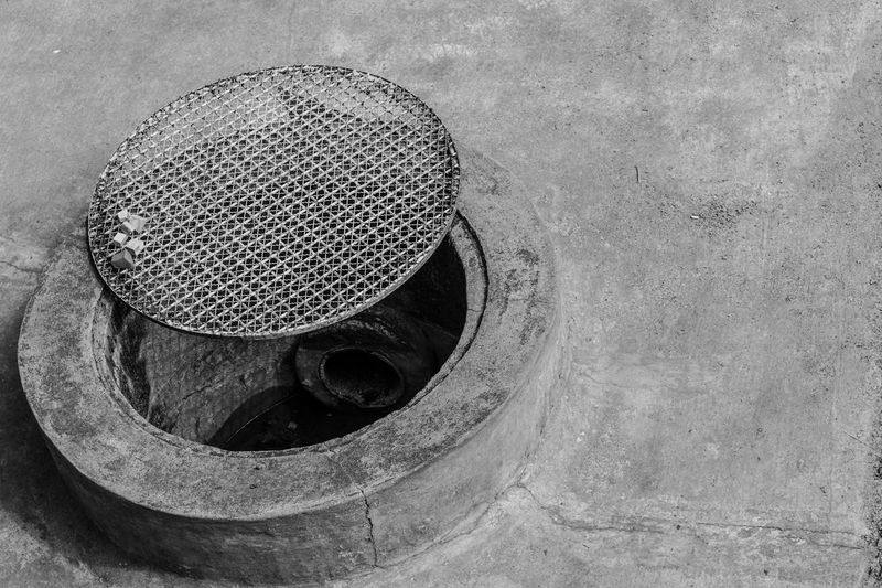 Close-up of open manhole on street