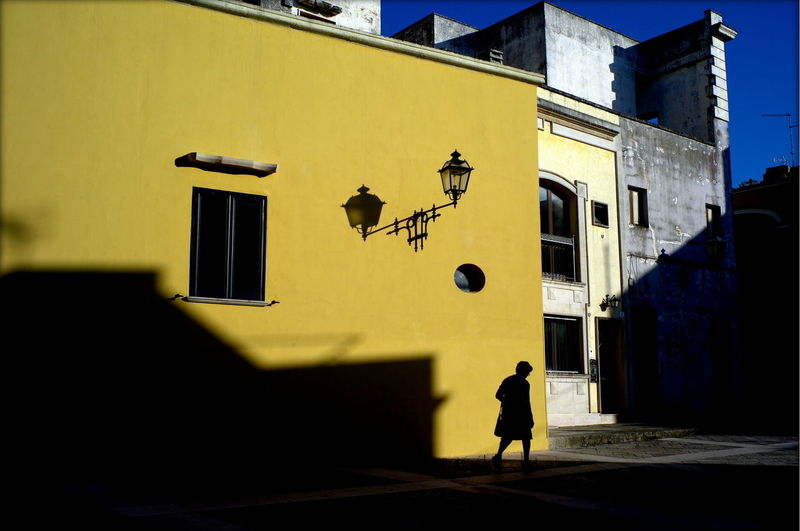 Street light in front of yellow building