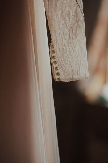 Close-up of clothes hanging on wood at home