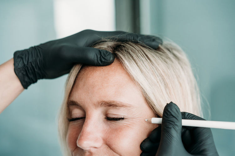 Young woman gets beauty facial injections in salon or clinic. skincare concept