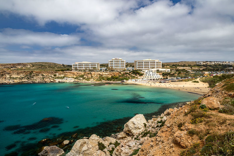 Scenic view of sea and buildings against sky