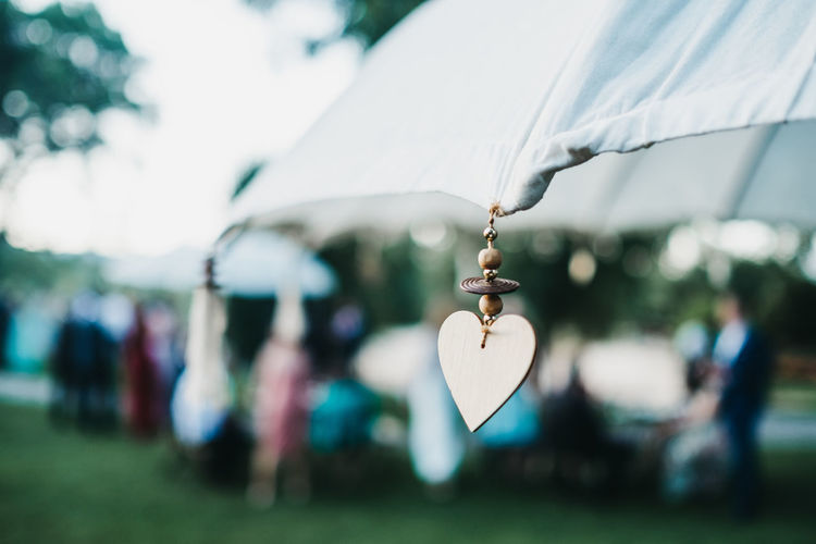 Close-up of heart shape decoration hanging on umbrella