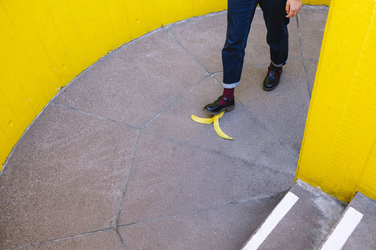 Young woman stepping on banana peel