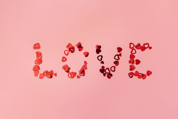 Close-up of heart shapes on pink background
