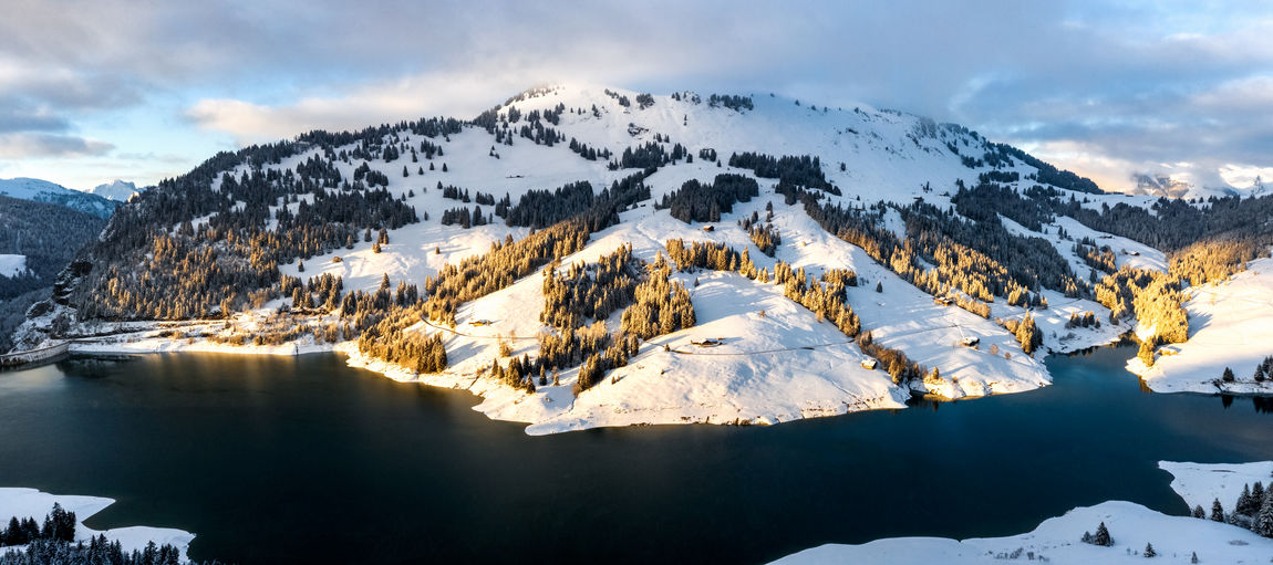 Aerial mountain lake view during sunset in winter