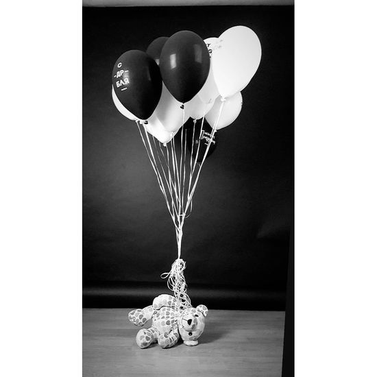 Close-up of balloons on table against white background