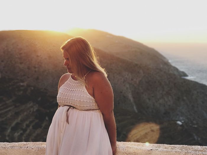 Pregnant woman standing against mountain