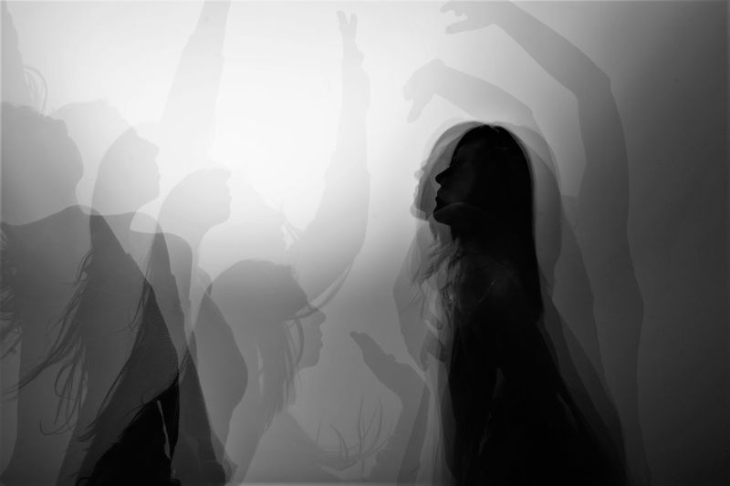 Rear view of a silhouette woman standing at night