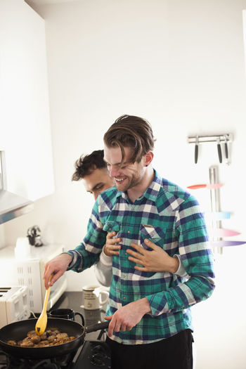Young couple cooking breakfast
