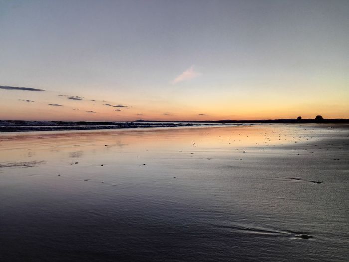 Scenic view of sea at sunset