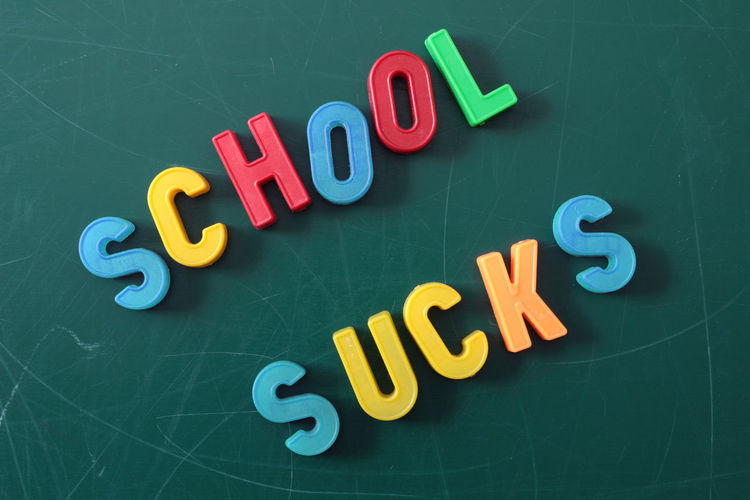 School sucks letter magnets on greenboard