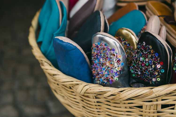Close-up of shoes in wicker basket for sale in market