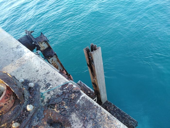 High angle view of rusty pier at sea