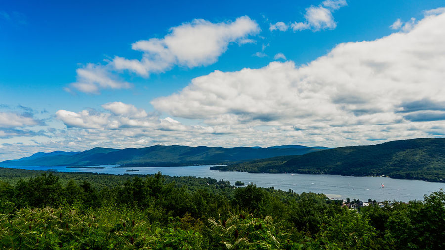 Scenic view of lake and mountains against sky
