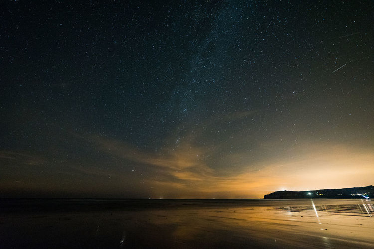 Scenic view of sea against sky at night