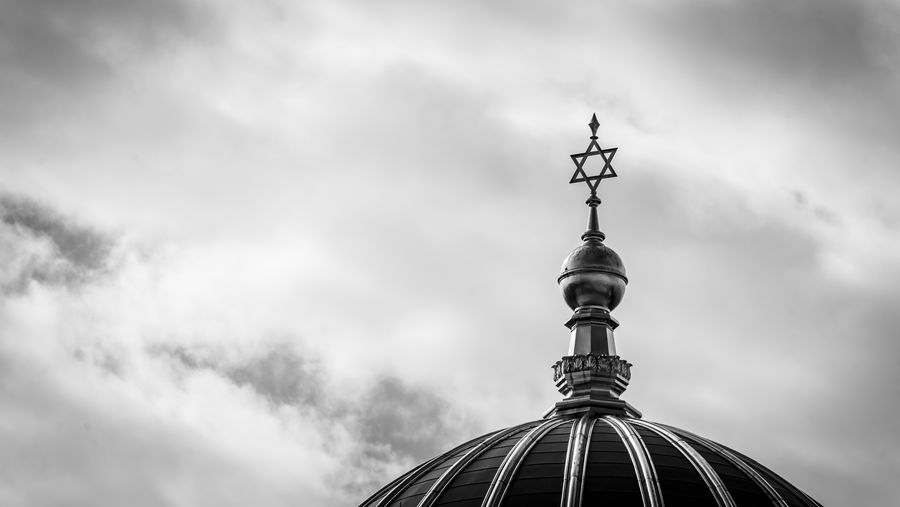Low angle view of a jewish church against cloudy sky
