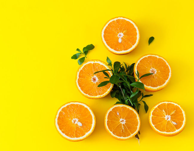 Directly above shot of lemon slice against orange background