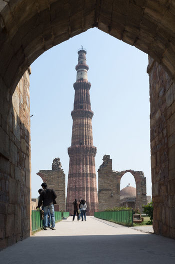 People walking in front of qutub minar
