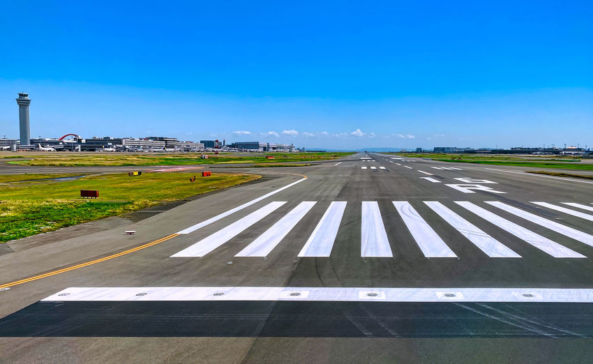 View of airport runway against blue sky