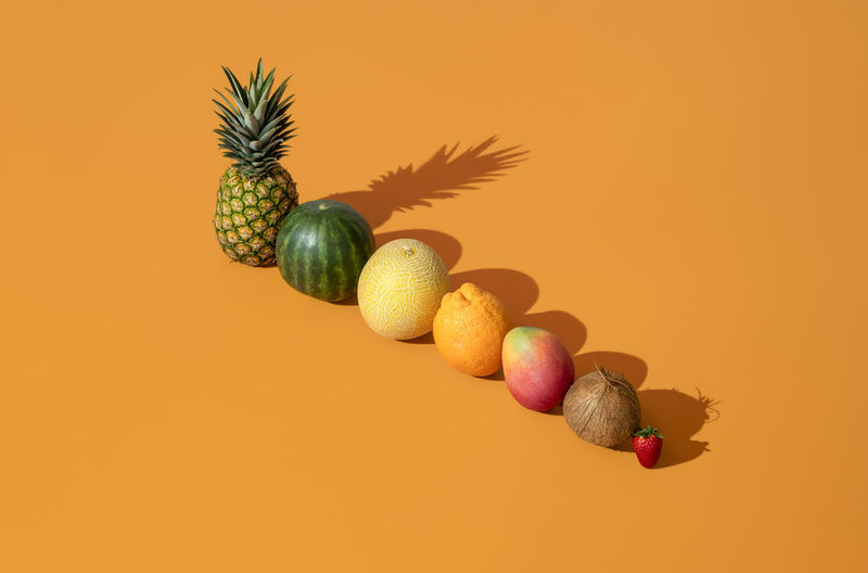 Close-up of bananas against orange background