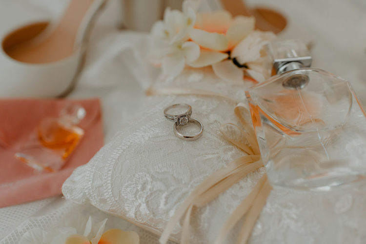 High angle view of wedding rings on white table