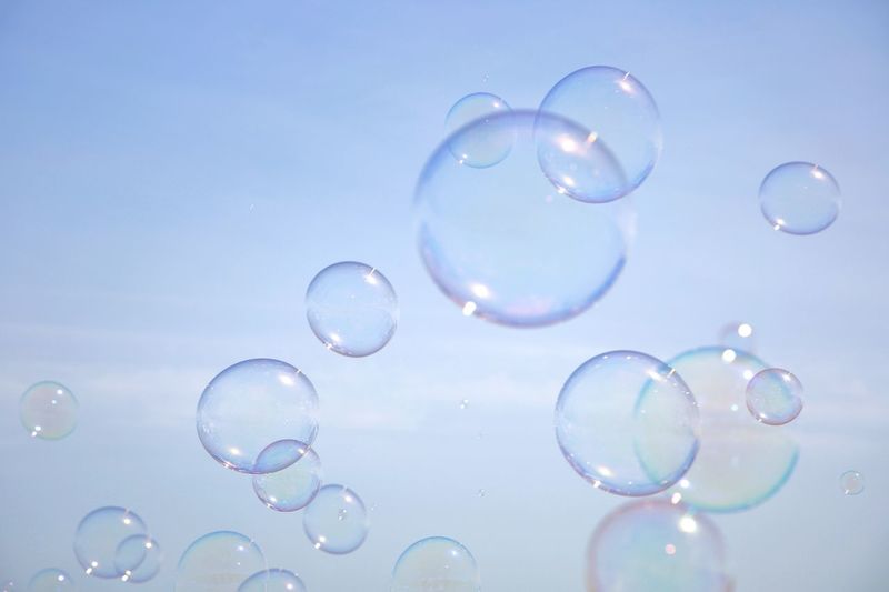 Close-up of bubbles in water against sky