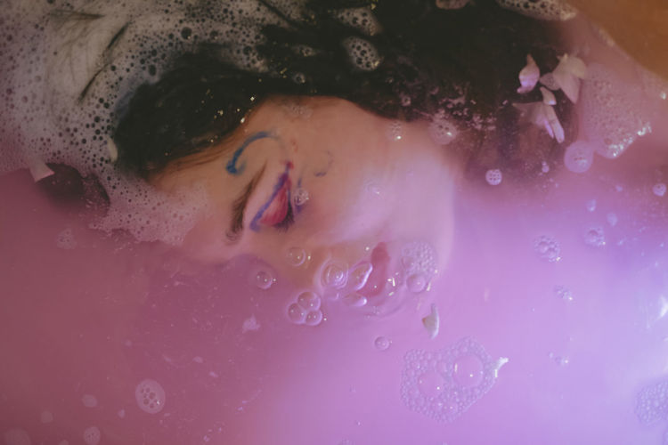 Close-up of young woman in bathtub
