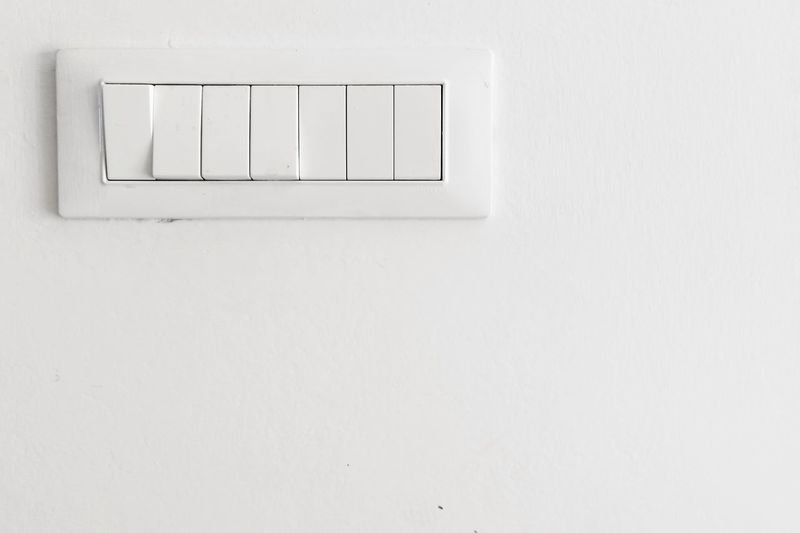 Close-up of light switches on white wall