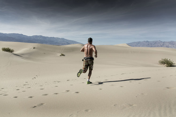 A man runs in the desert sand in death valley