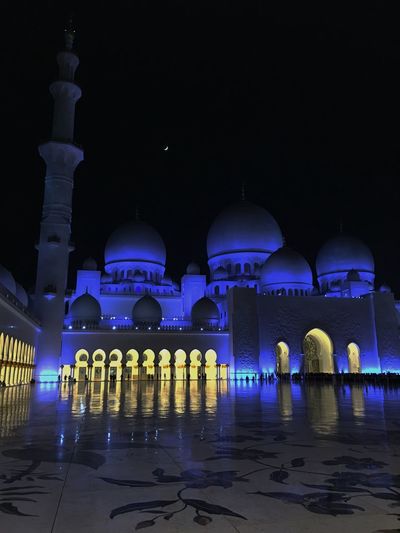 Low angle view of illuminated sheikh zayed mosque against sky at night