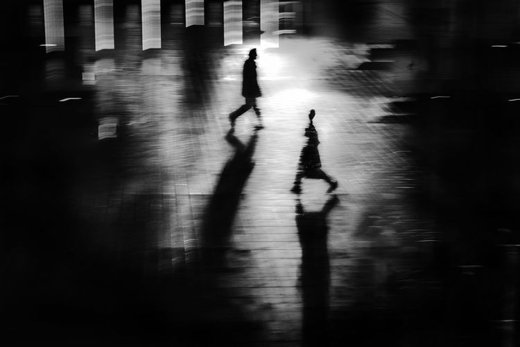 High angle view of silhouette people walking on street