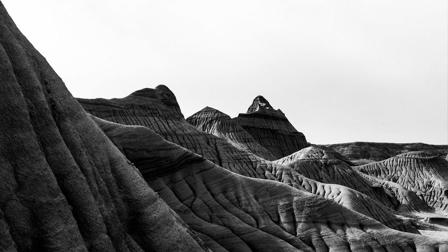Low angle view of rock formations in desert against clear sky