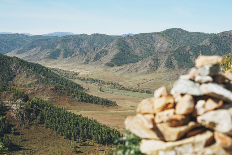 Pile of stones pyramid on background of the valley in altai mountains