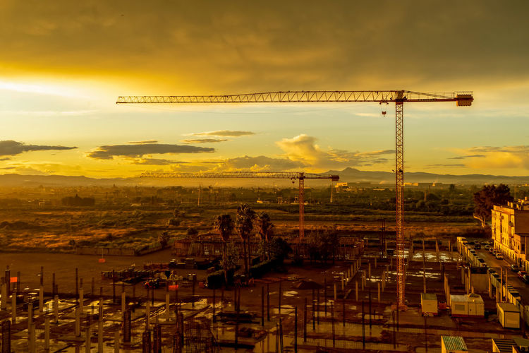 High angle view of construction site against sky during sunset