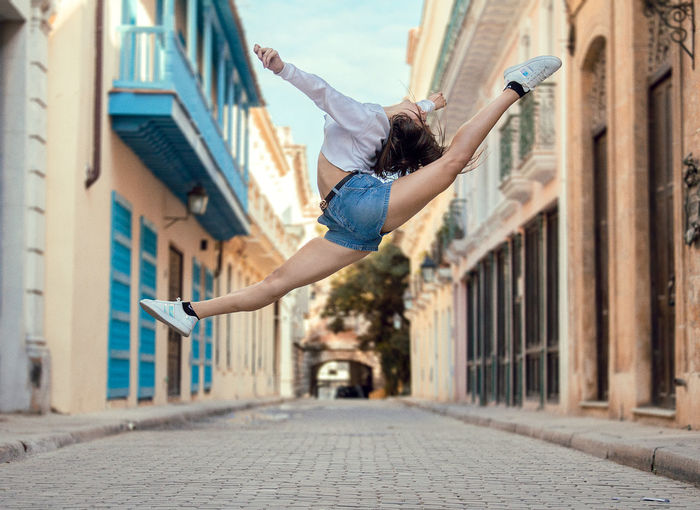 Low angle view of a dancer jumping on street