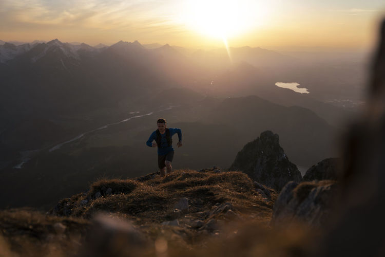 Man hiking on sauling mountain at sunset