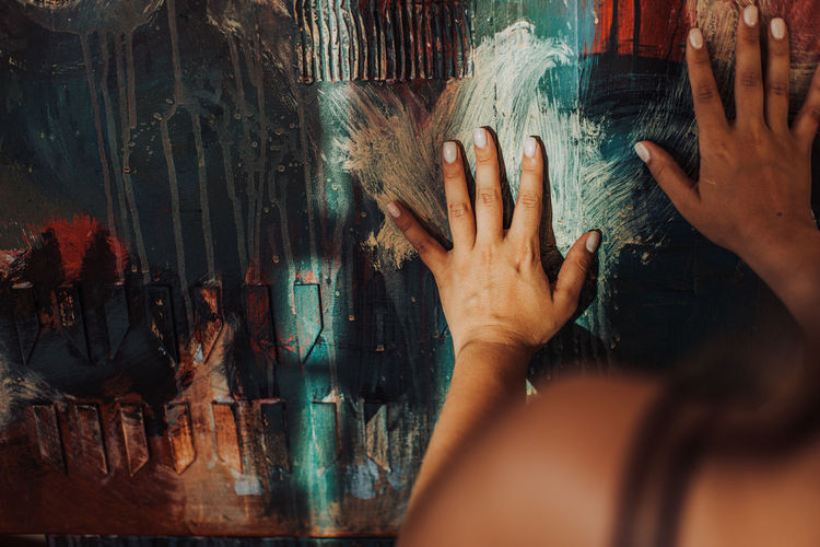 Hands of a painter on canvas