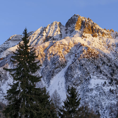 Low angle view of snowcapped mountain against sky
