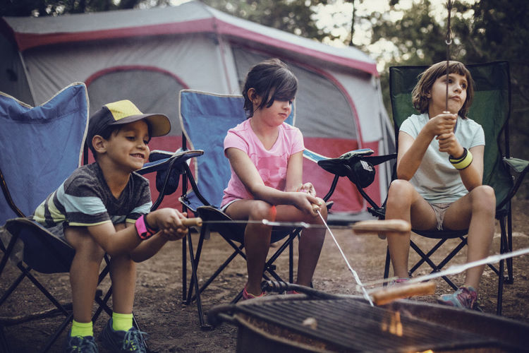 Siblings barbecuing in forest