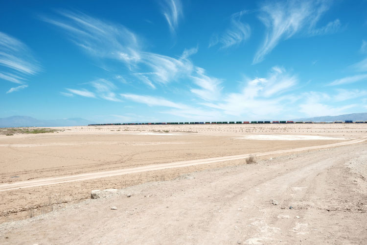 Scenic view of desert against blue sky