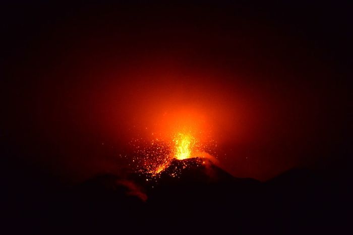 Explosion of molten lava at night