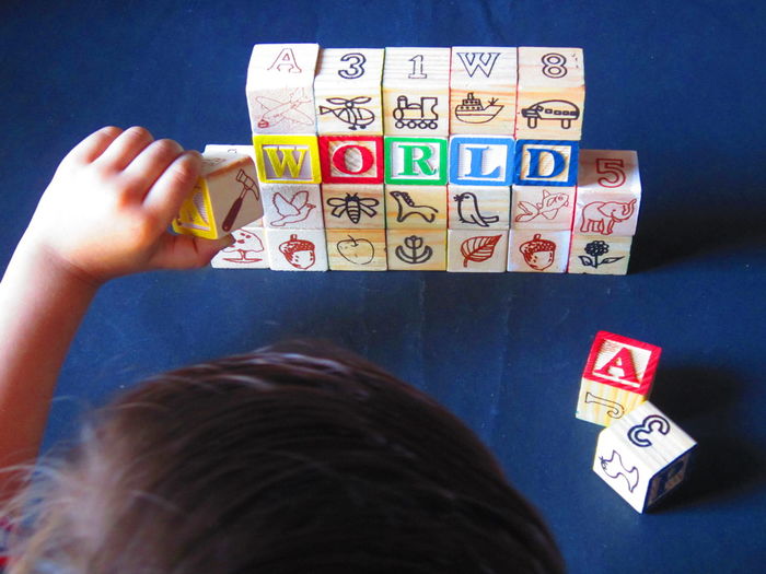 Close-up of child playing with blocks