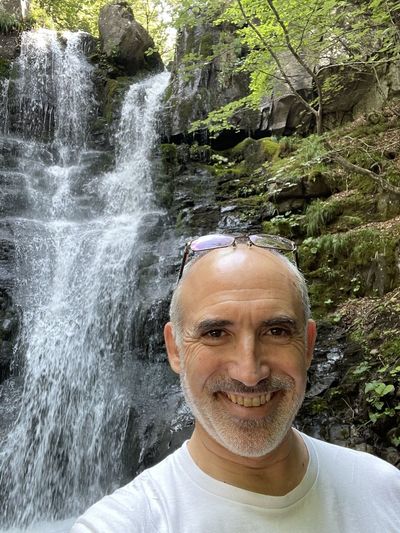 Portrait of smiling man in waterfall