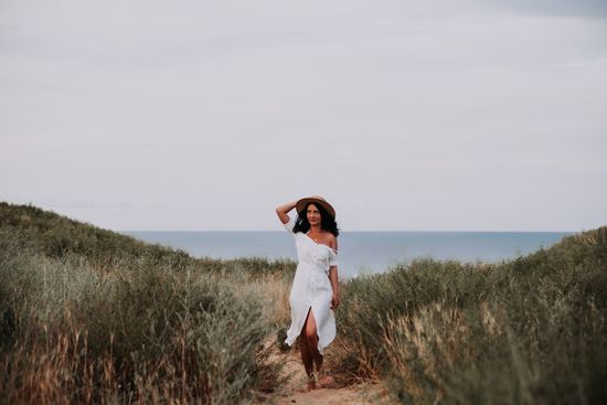 Woman standing on beach against sky